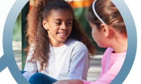 two girls talking and smiling