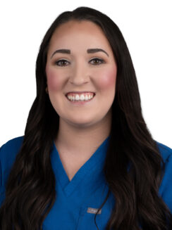Brianna Massingill, Clinical Research Professional, Long Dark hair wearing a blue scrub top.