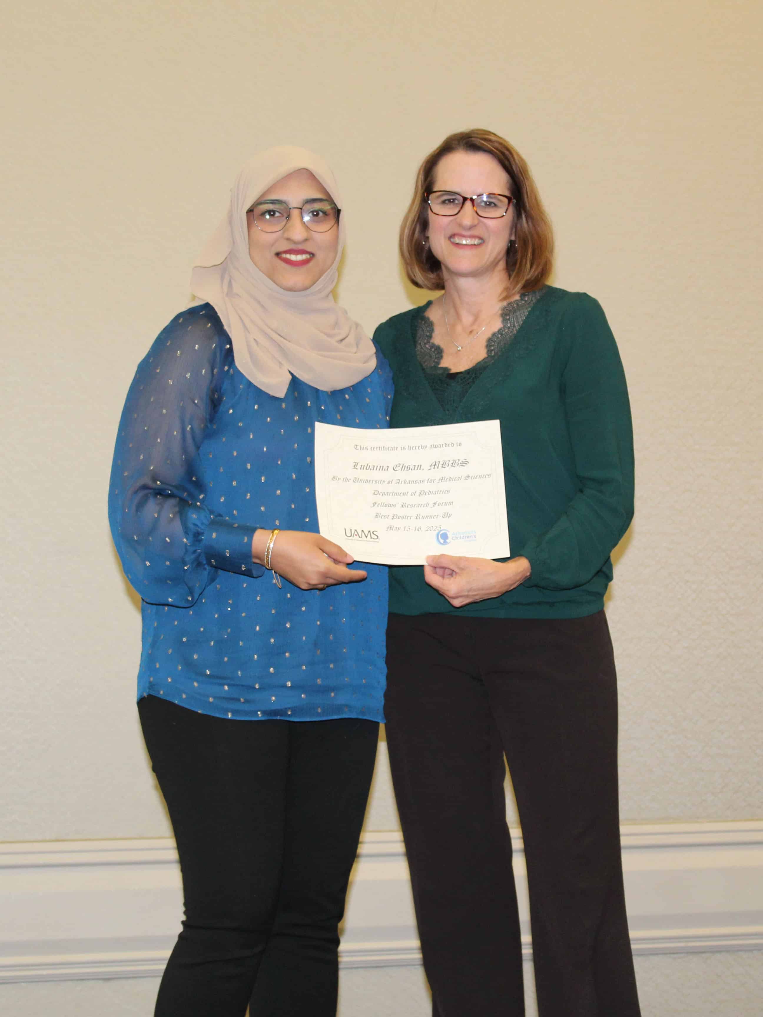 Dr. Jill Fussell presents the Best Poster Runner Up, Dr. Lubaina Ehsan, with a certificate
