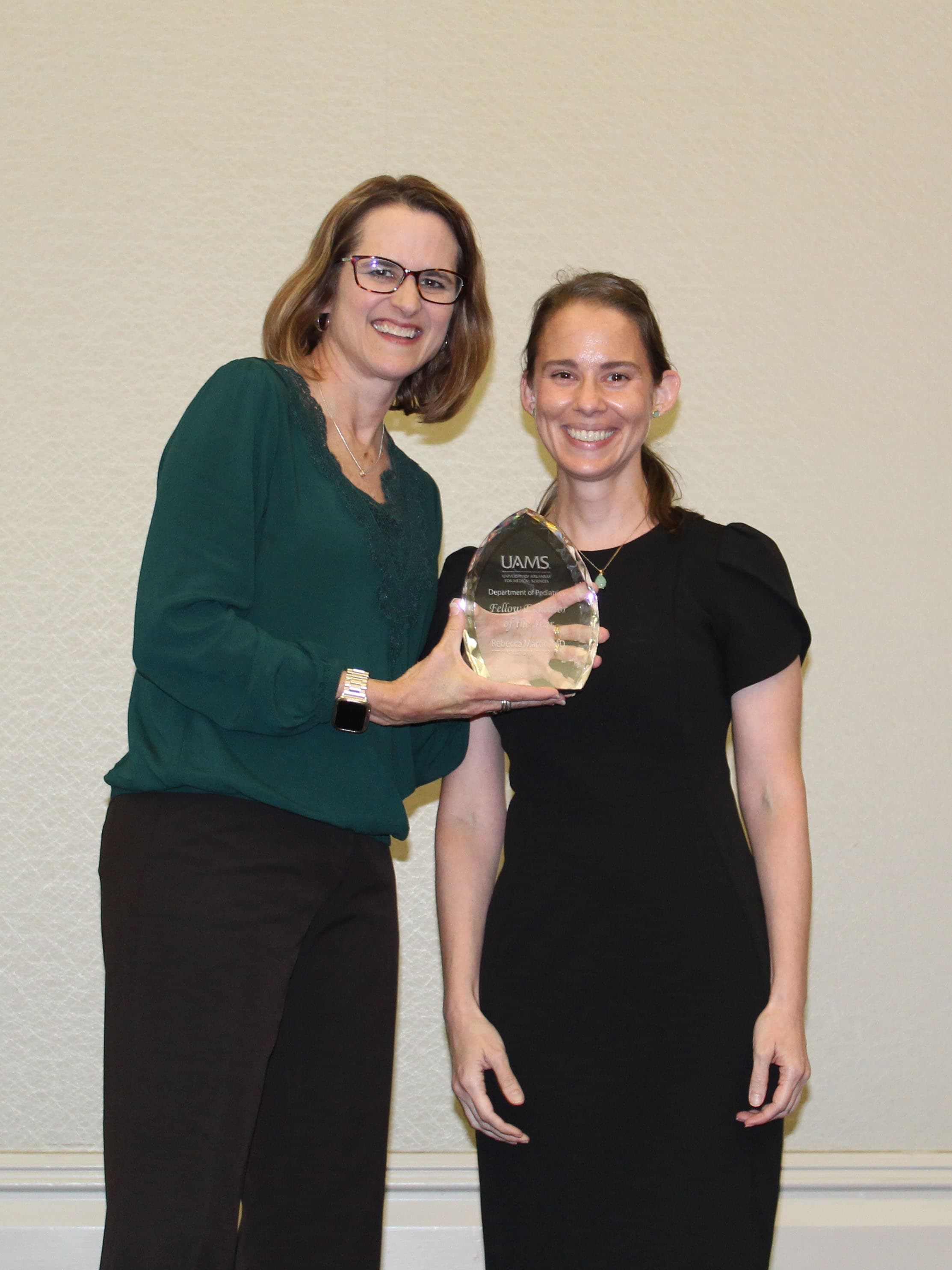 Dr. Jill Fussell presents the Fellow Educator of the Year, Dr. Rebecca Martin, with the award