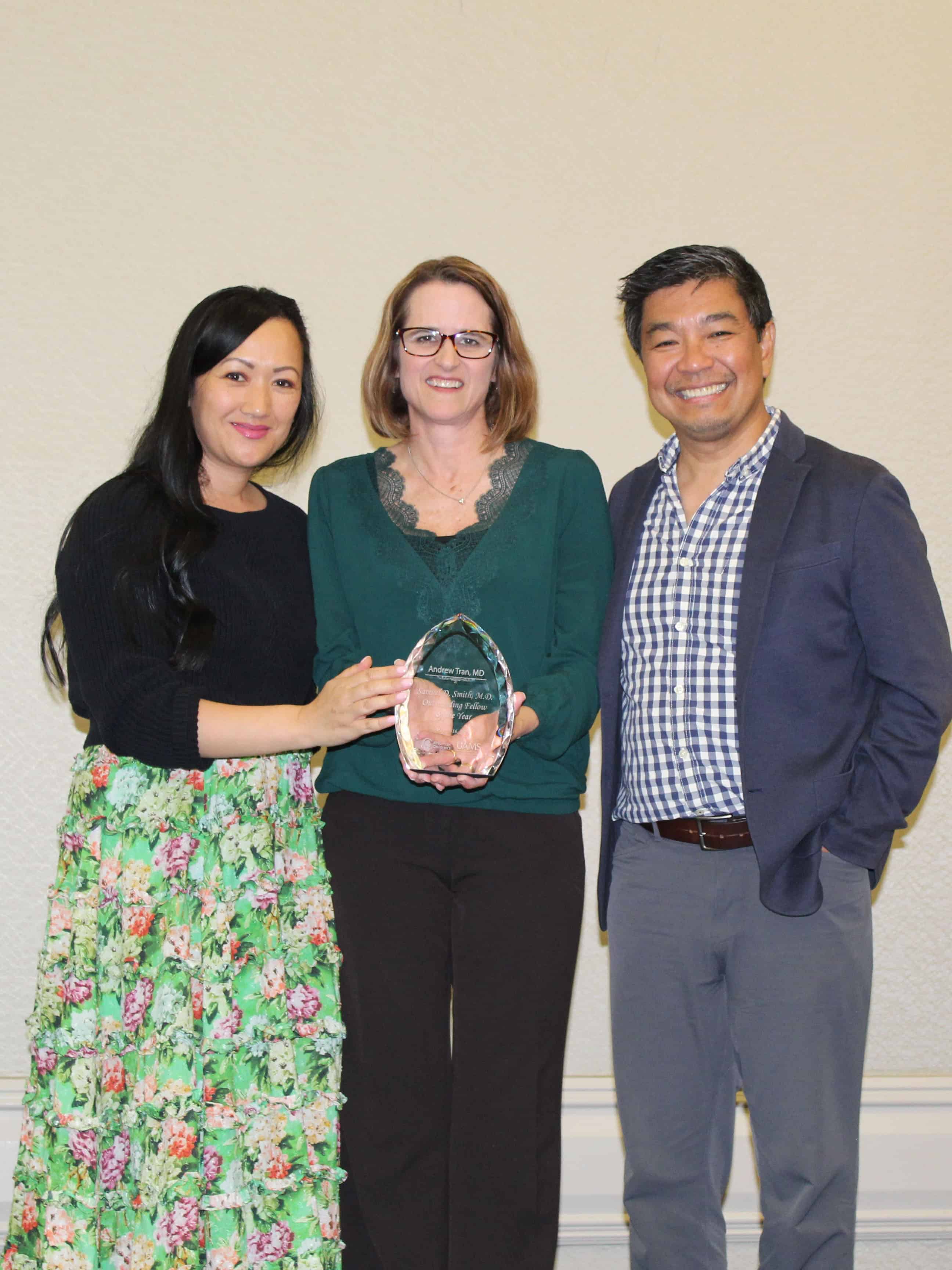 Dr. Jill Fussell holds the award for the Samuel D. Smith Fellow of the Year. The winner, Dr. Andrew Tran, was working at the hospital and his program directors accepted the award, Dr. Joanna Mack and Dr. Pele Yu.