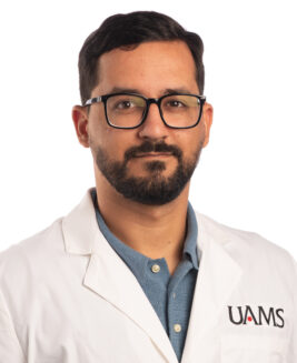 Lucas Veras, Postdoctoral Fellow, wearing a UAMS labcoat