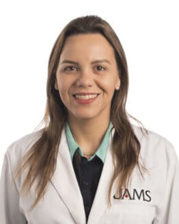 Professional headshot in lab coat of Dr. Amanda Costa