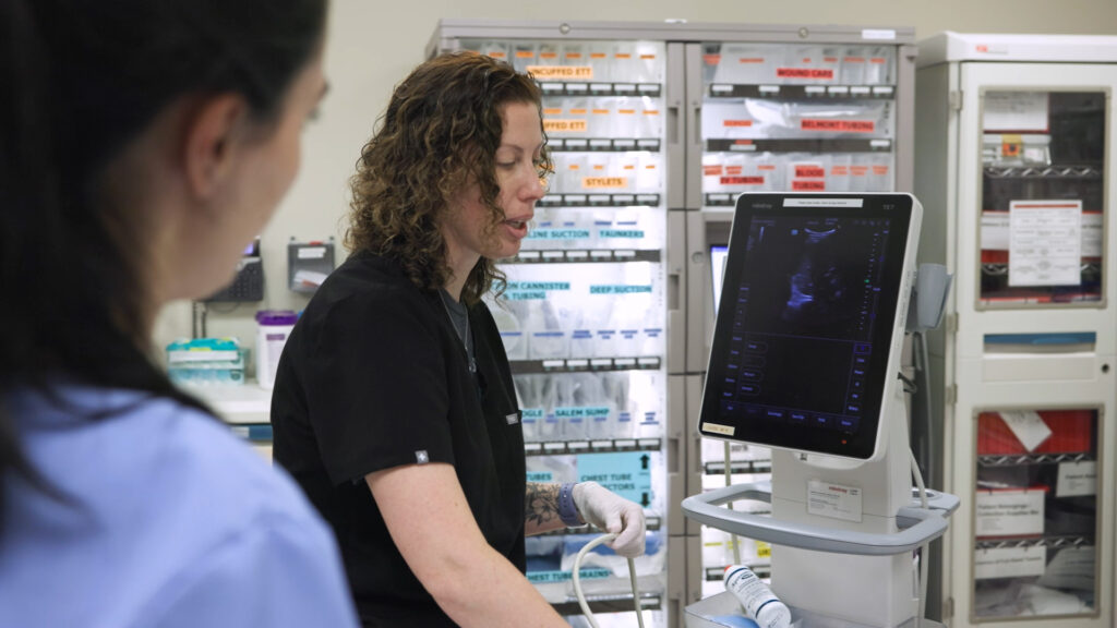 Dr. Amber Morse instructs a fellow in a trauma room.