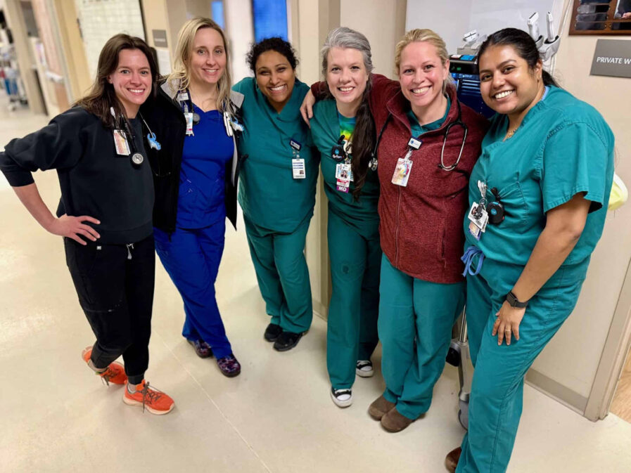 Female nurses and doctors pose together in the Emergency Room for Women's Day 2026