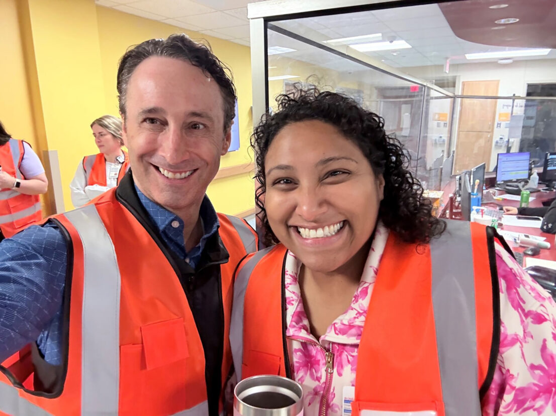 Dr. David Spiro and Dr. Renita Pushparajah take a photo wearing orange safety vests in the Emergency Department