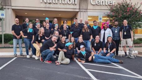 all ACNC staff who attended Fall Fest 2024 standing in front of the ACNC building in matching shirts.