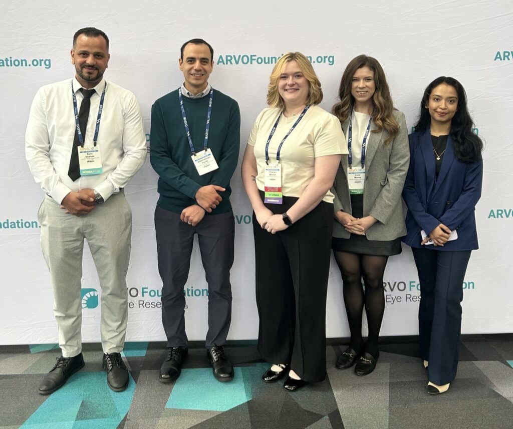 group photo of lab members at a conference