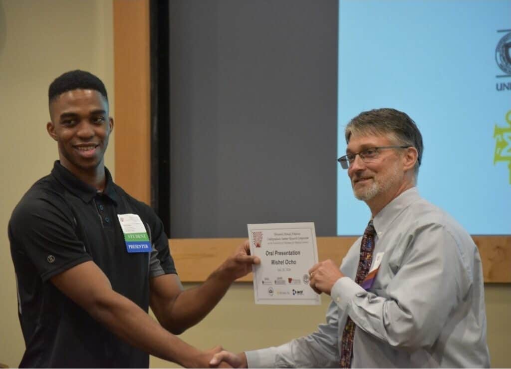 SURF student being presented an award at ASPET.