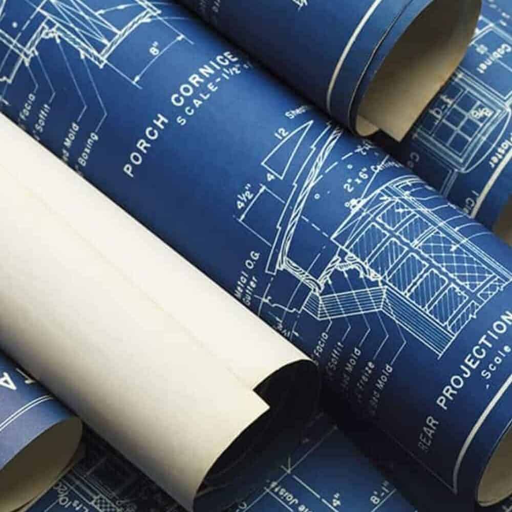 several rolled blueprints that depict office spaces