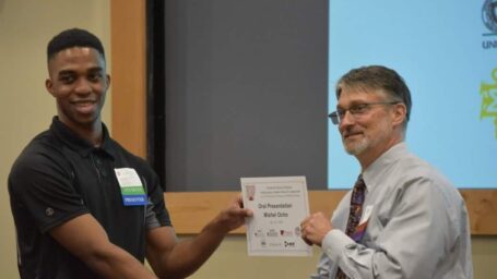 SURF student being presented an award at ASPET.