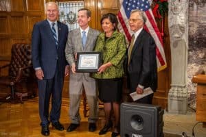 faculty members posing with Governor Hutchinson