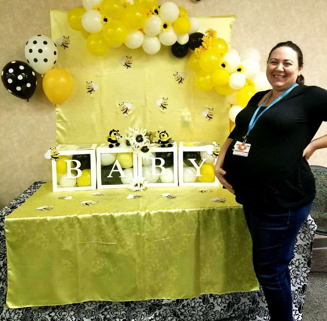 Onal posing with baby shower decorations