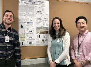 Students standing in front of research poster