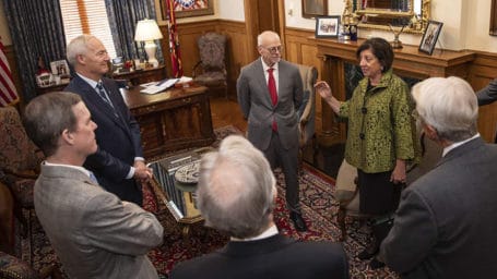 Dr. Bellido with Arkansas governor and others