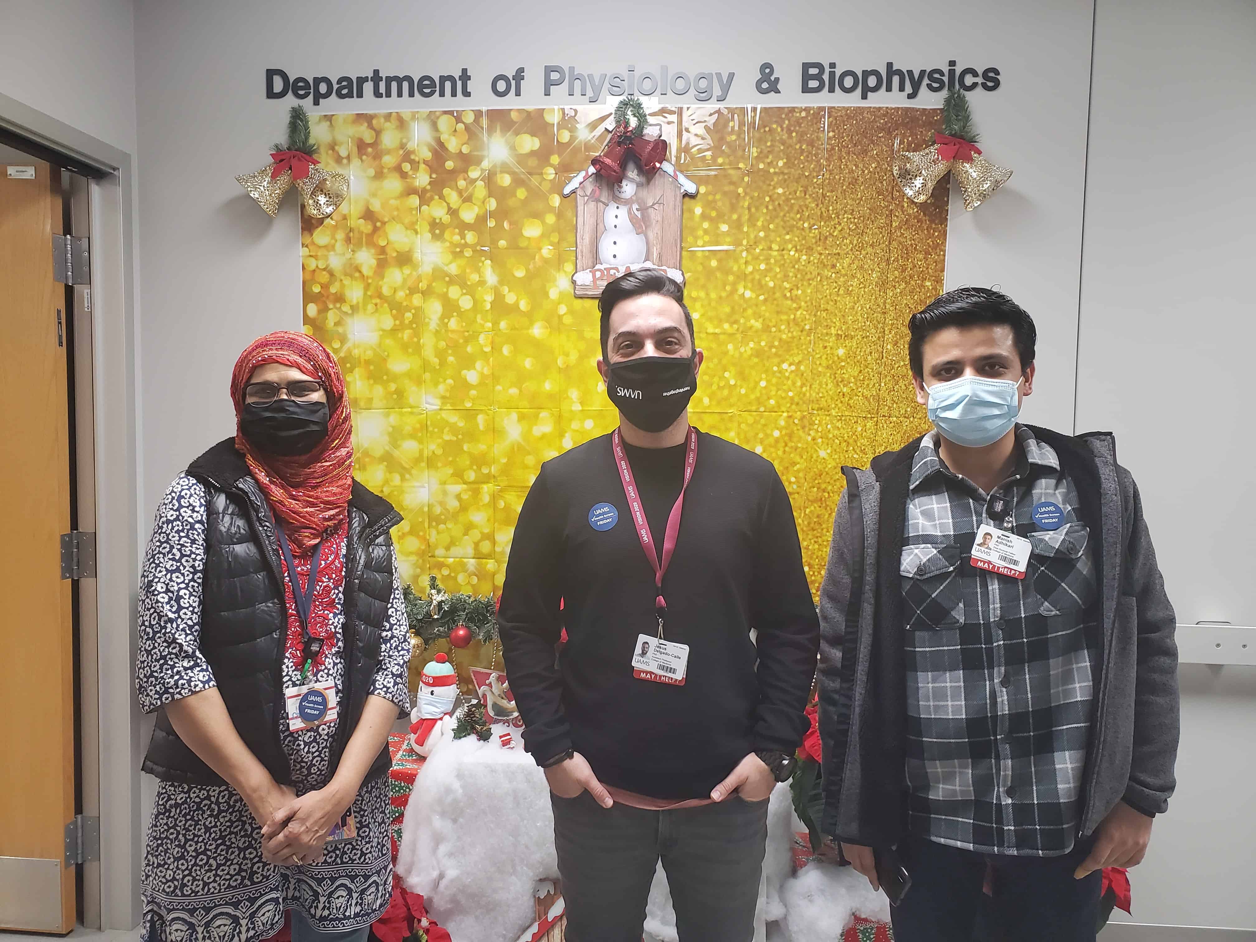 Delgado lab members in front of the display
