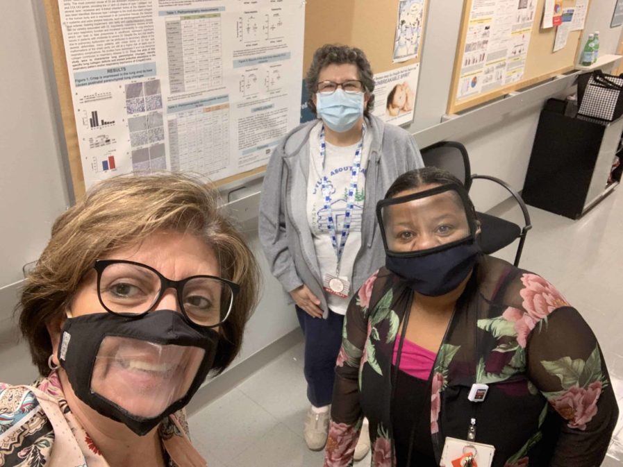 Dr. Bellido with masked staff members in the hallway