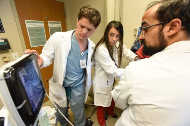 Doctors examining a screen
