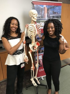 Saint Adeogba, M.D., with resident and skeleton