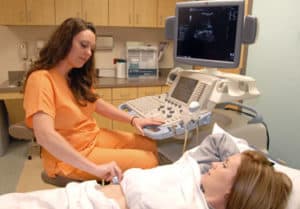 Radiographer conducting an ultrasound on a patient
