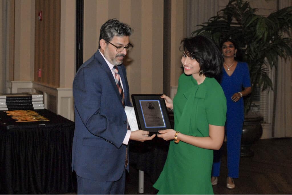 Photo of Dr. Surbhi Raichandani receiving award.