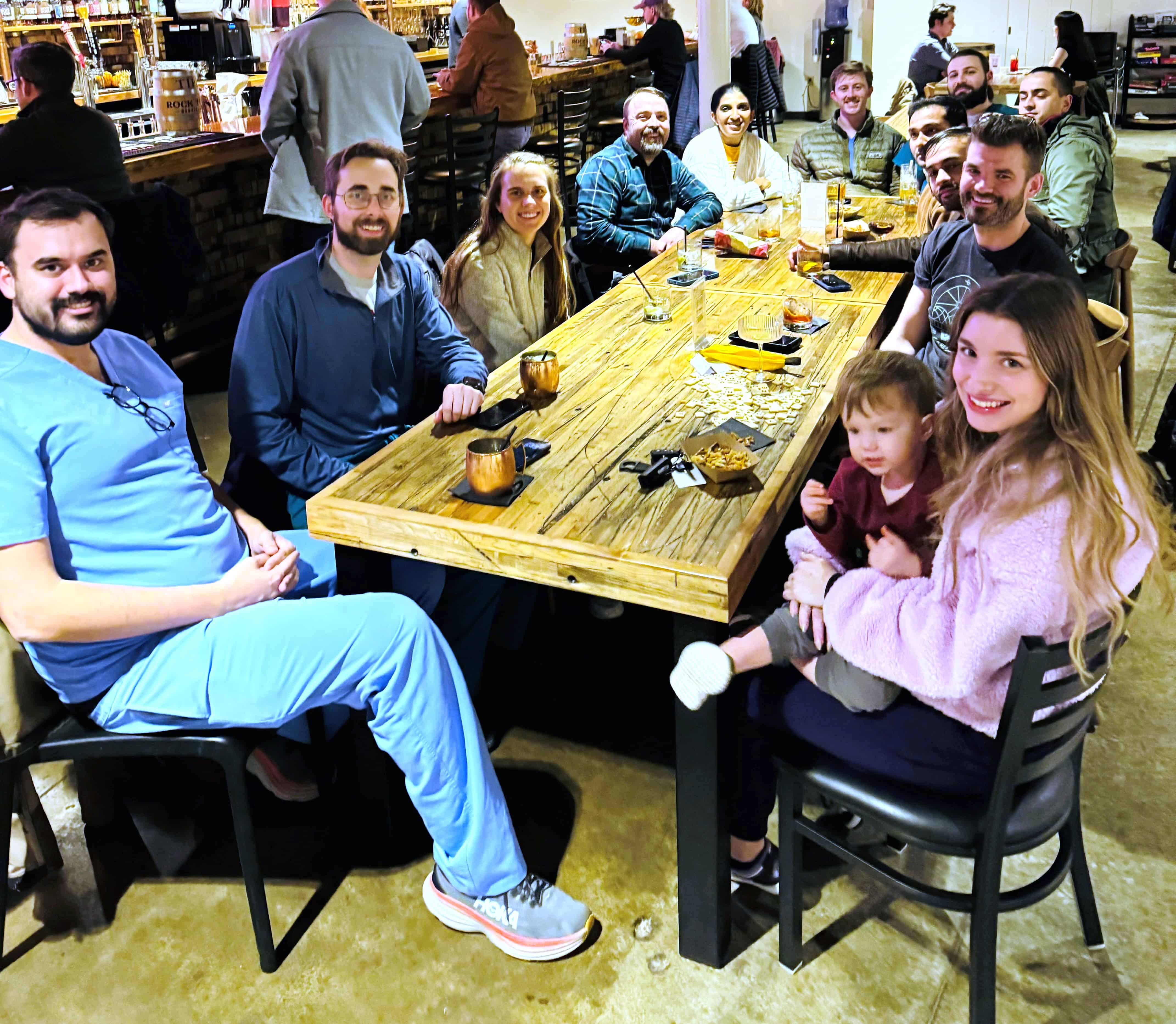 Residents sitting at a table during Happy Hour