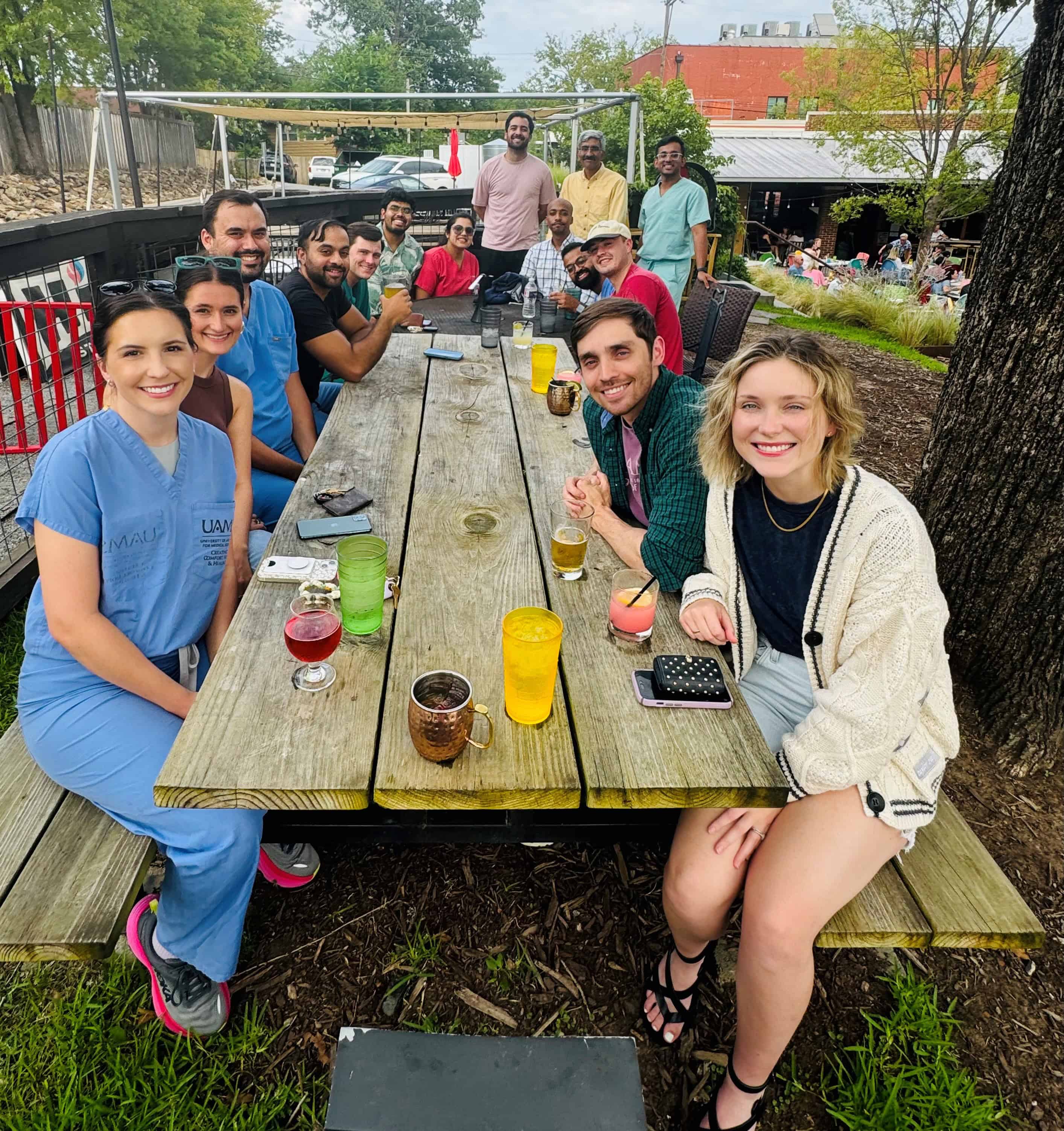 Residents sitting at picnic tables, posing for photo