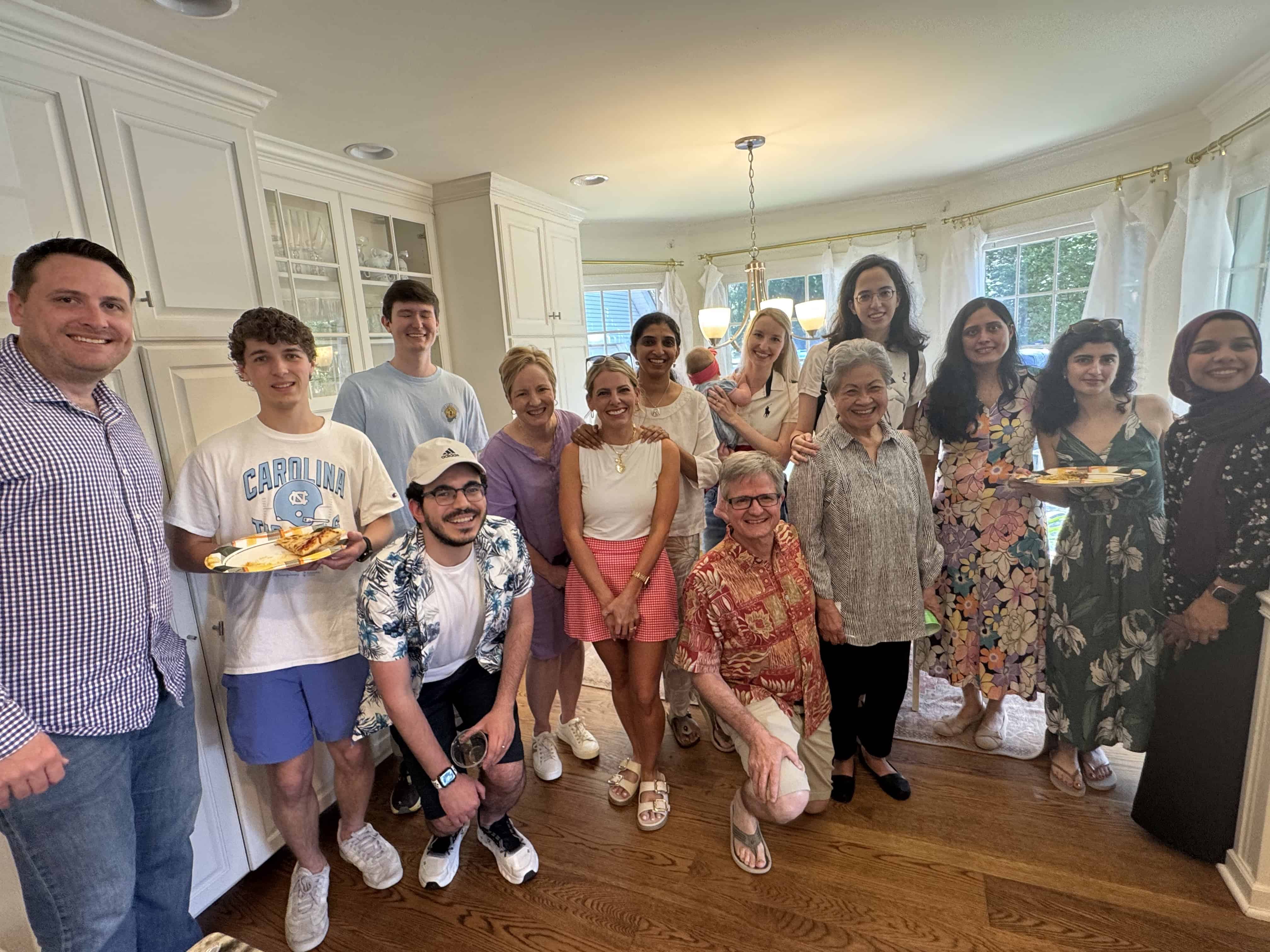 People in a kitchen posing for a photo.
