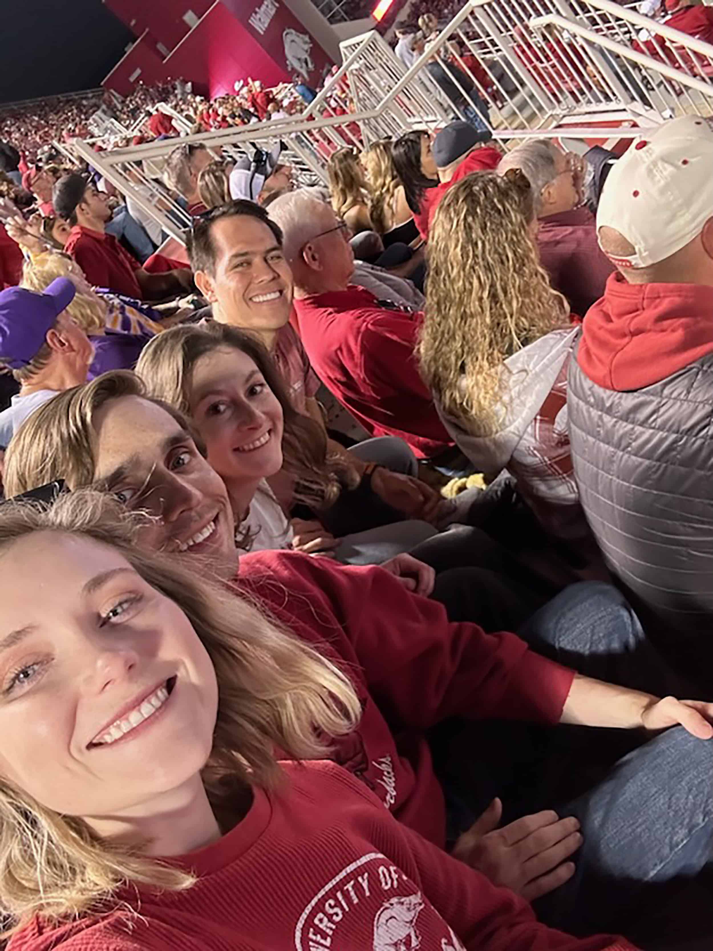 Residents posing for a photo at a football game.