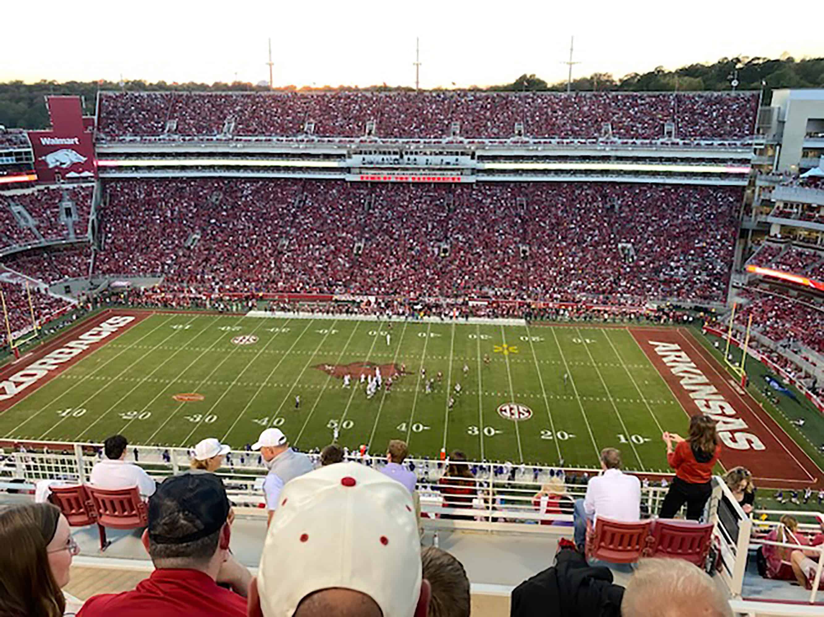 Football field with people watching a game.