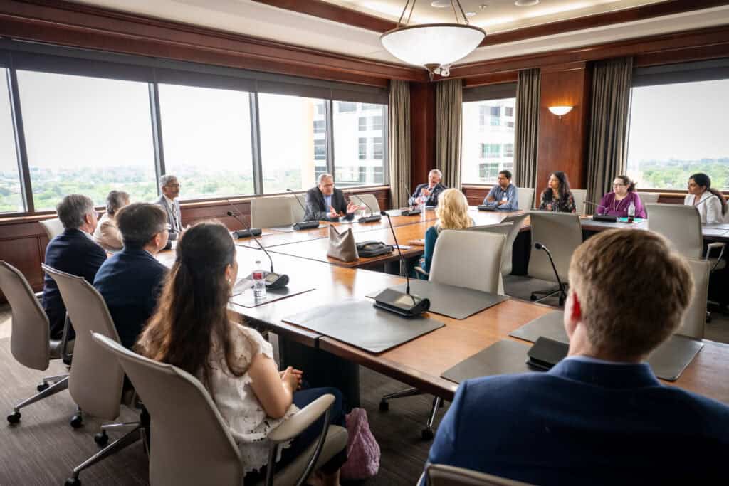 People sitting at conference tables.