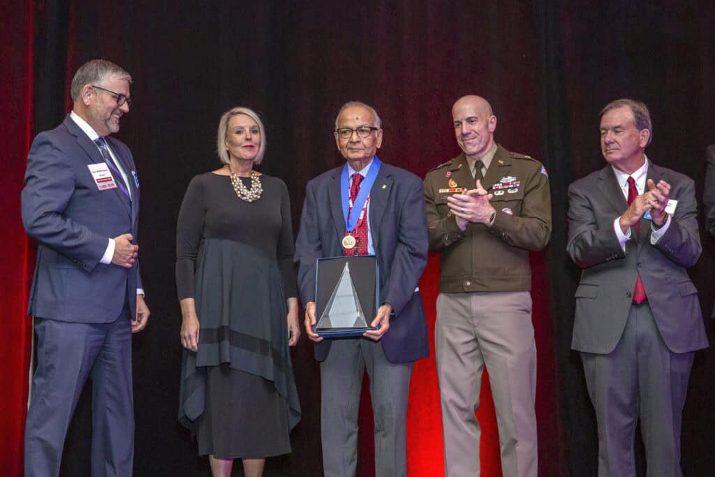 Doctor posing with award.