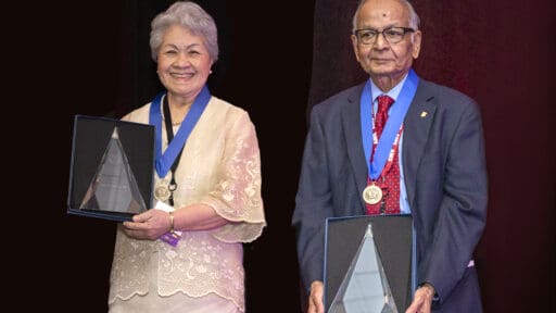 Two physicians posing with awards.