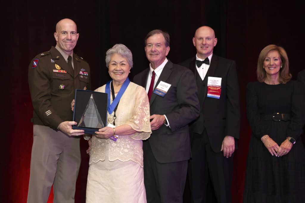Doctor posing with award.