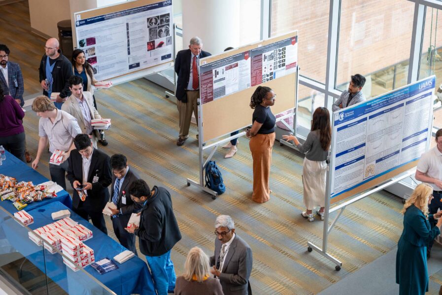 Photo of People looking at posters.