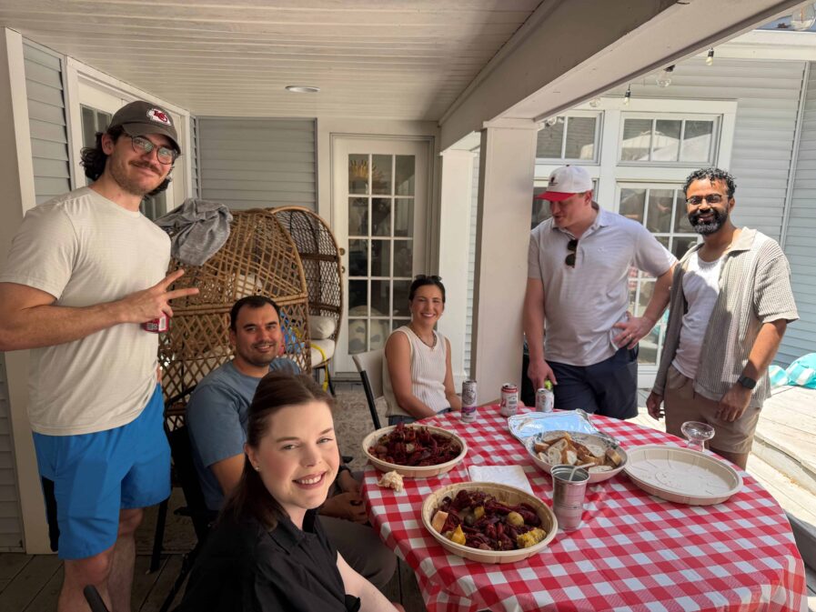 People sitting around a table outside.