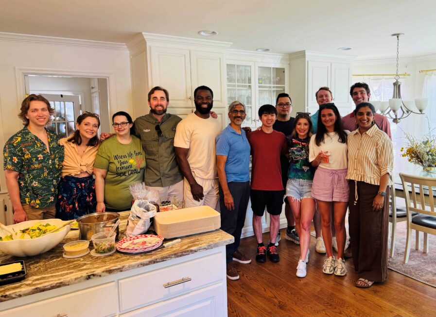 People posing for a photo in a kitchen.