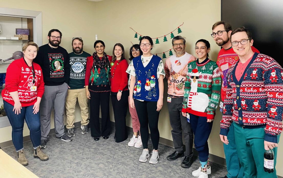 Photo of residents posing in ugly sweaters.