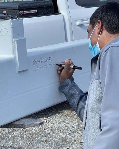 Dr. Sanjay Maraboyina signs final beam for new Radiation Oncology building.