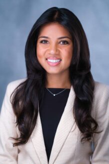 Resident Ashini Patel, MD in a suit and blazer smiling.