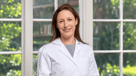 Female physician in front of a window