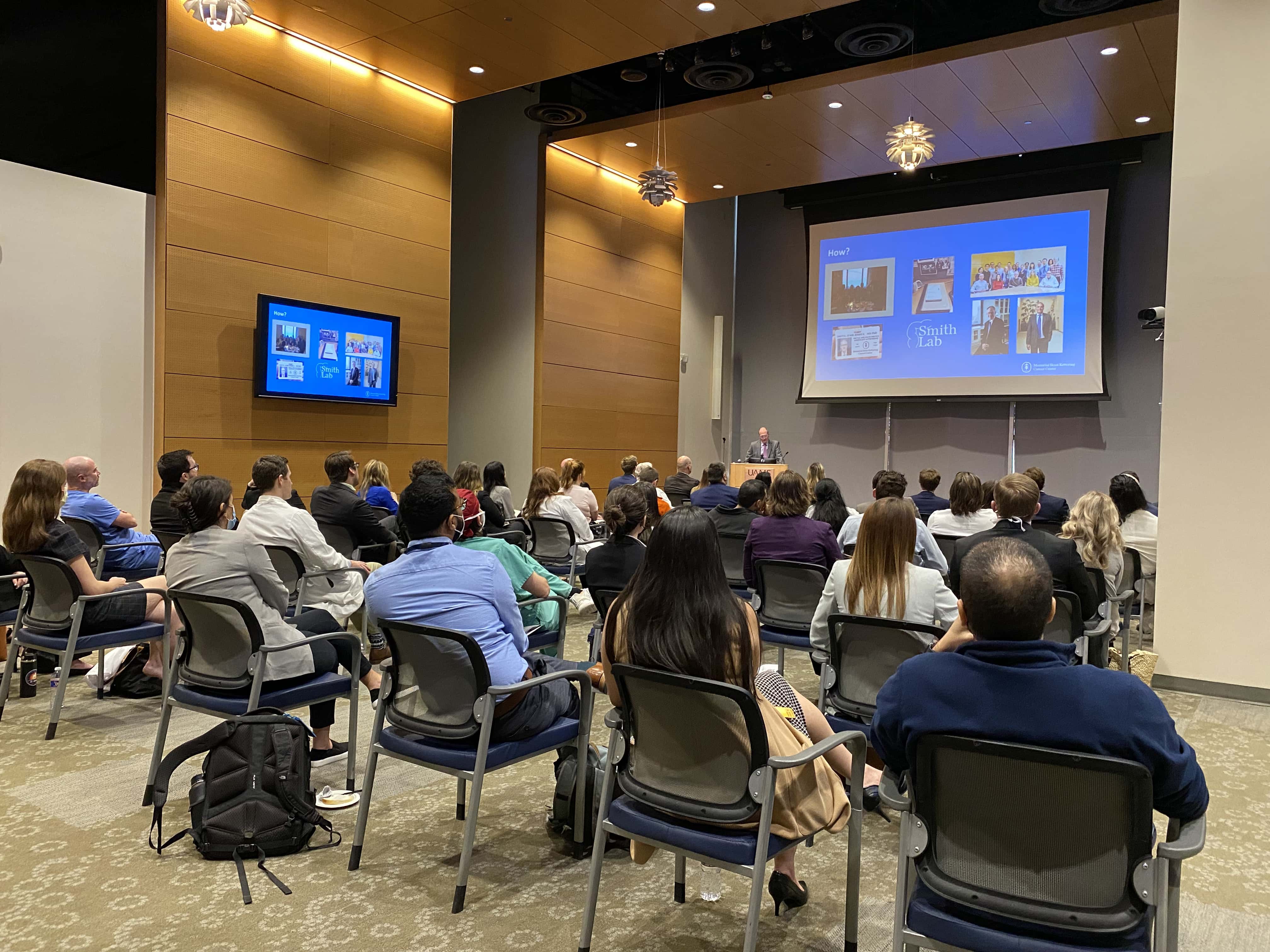 Room full of people listening to the keynote speaker in an auditorium