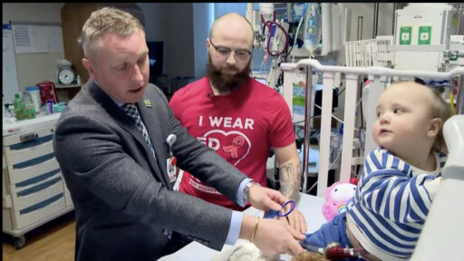 Doctor and father examine toddler in the hospital