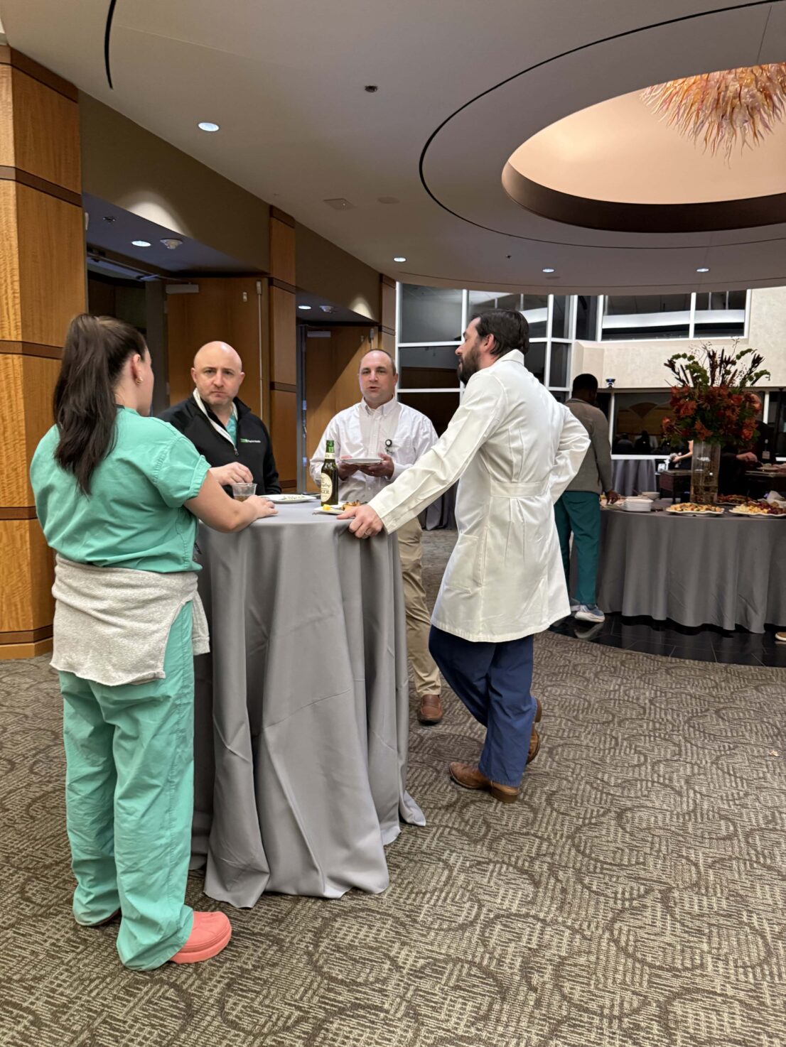 group of people talking around a table in the lobby