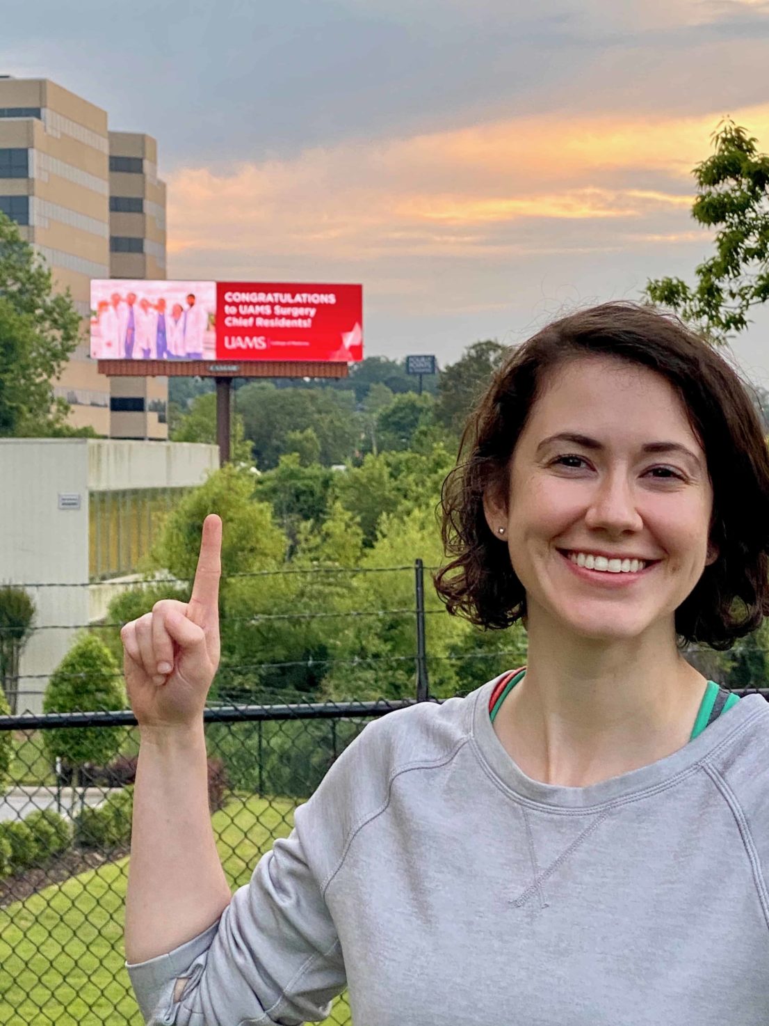 chief resident points to a billboard congratulating the chief residents