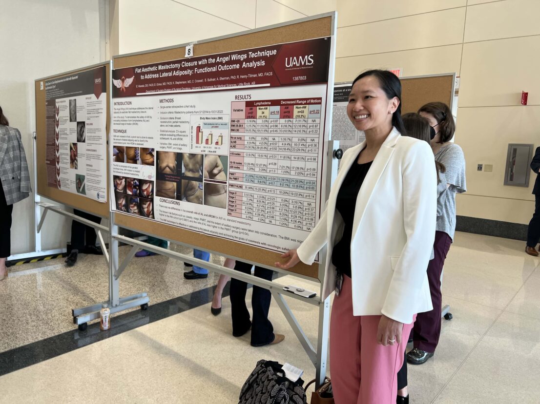 Woman pointing to her research poster