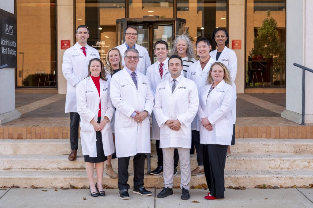 Urology faculty poses on the steps of a building on the UAMS campus in Little Rock