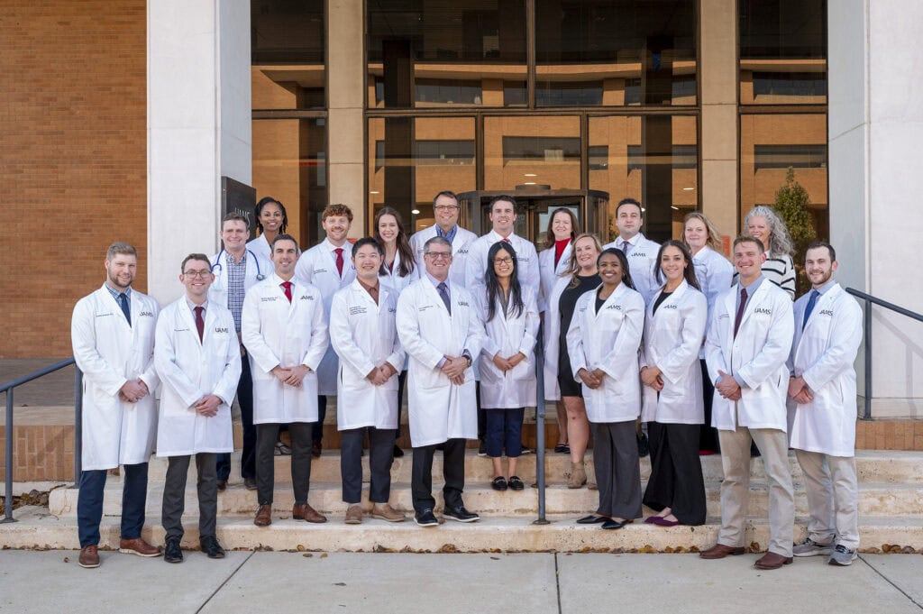 Urology faculty and residents pose on the steps of a building on the UAMS campus.