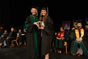 Faculty member and student with award