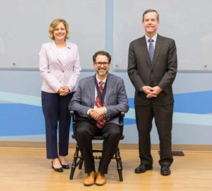 Dr. Hartzell in endowed chair; Ms. Doderer and Dr. Patterson standing alongside